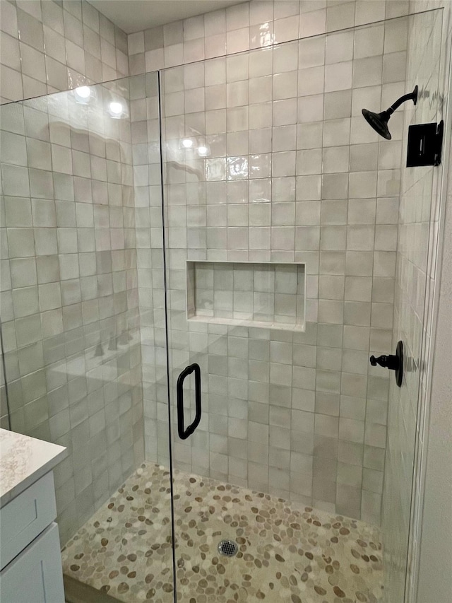 full bath featuring a stall shower and vanity