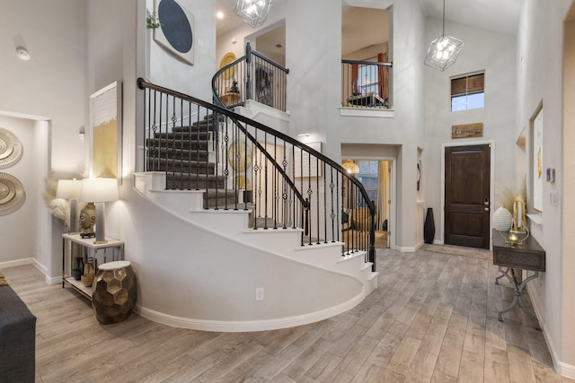 entrance foyer with a high ceiling and light hardwood / wood-style flooring