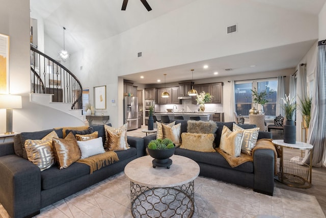 living room featuring high vaulted ceiling and ceiling fan