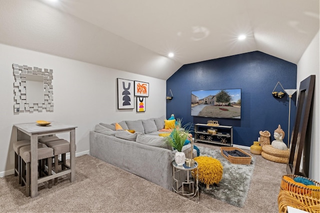 carpeted living room featuring vaulted ceiling