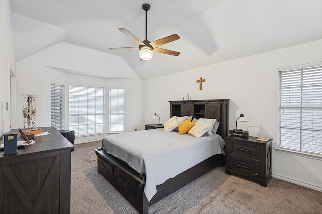 bedroom with multiple windows, vaulted ceiling, and light colored carpet