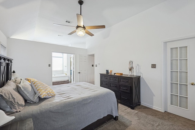 bedroom with lofted ceiling, ensuite bath, light colored carpet, and ceiling fan