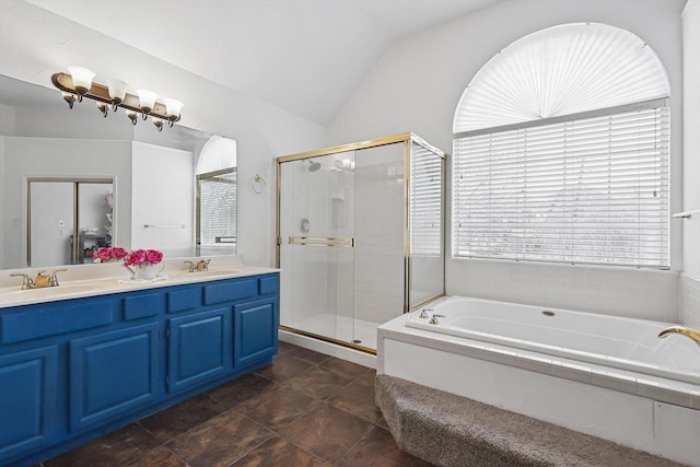 bathroom with independent shower and bath, vanity, and vaulted ceiling