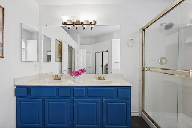 bathroom featuring vanity and a shower with shower door