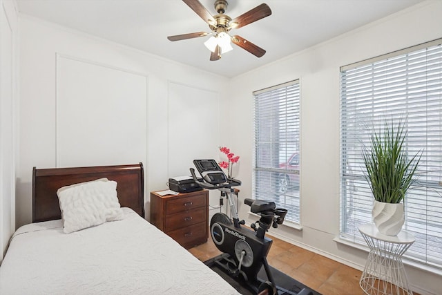 bedroom with ornamental molding and ceiling fan