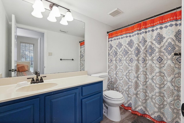 bathroom with a shower with curtain, vanity, toilet, and wood-type flooring