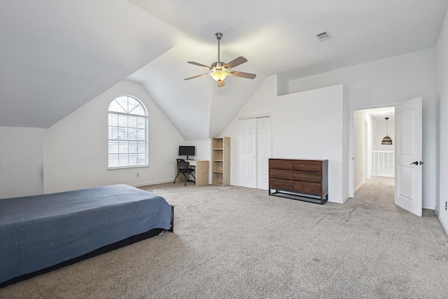 bedroom with lofted ceiling, light colored carpet, a closet, and ceiling fan