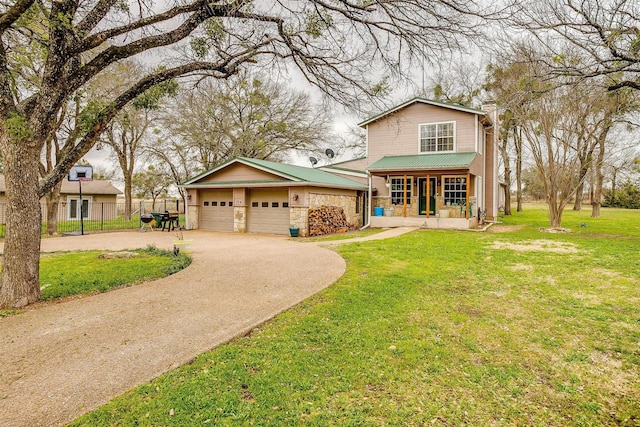 view of front facade featuring a garage, covered porch, and a front lawn