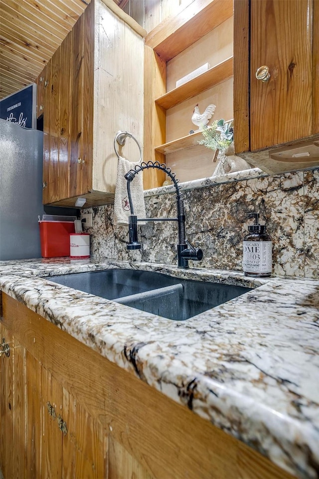 details featuring tasteful backsplash and sink