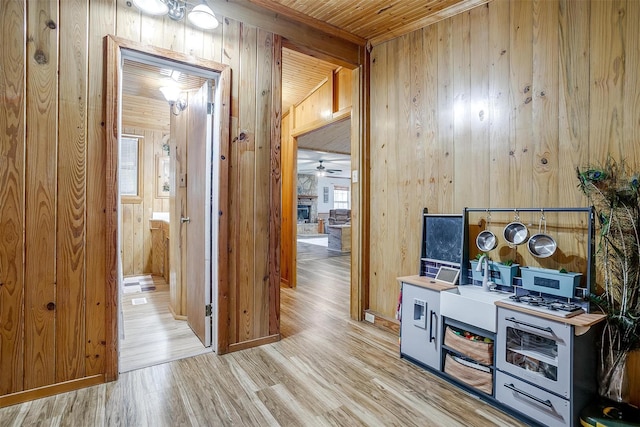 interior space featuring wooden ceiling, light hardwood / wood-style flooring, and wood walls