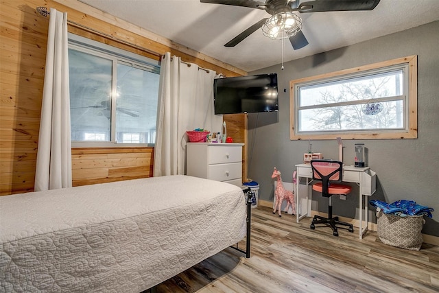 bedroom with ceiling fan and wood-type flooring