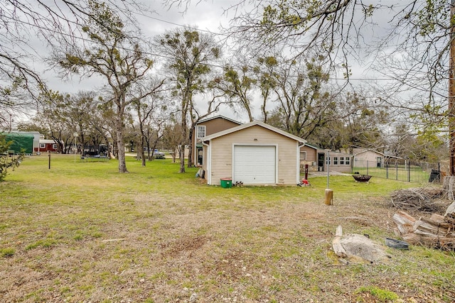 view of yard featuring a trampoline and a garage