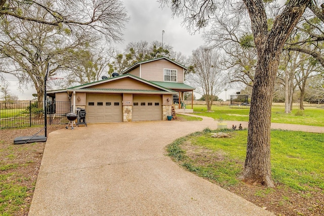 view of front of property featuring a garage and a front lawn