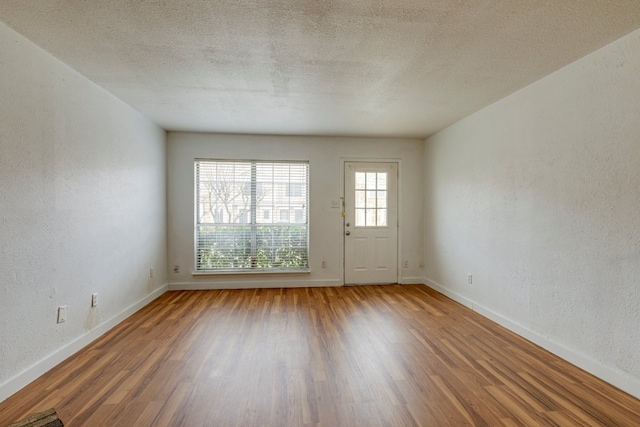 interior space featuring wood-type flooring and a textured ceiling