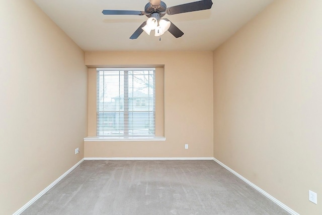 spare room featuring ceiling fan and light carpet