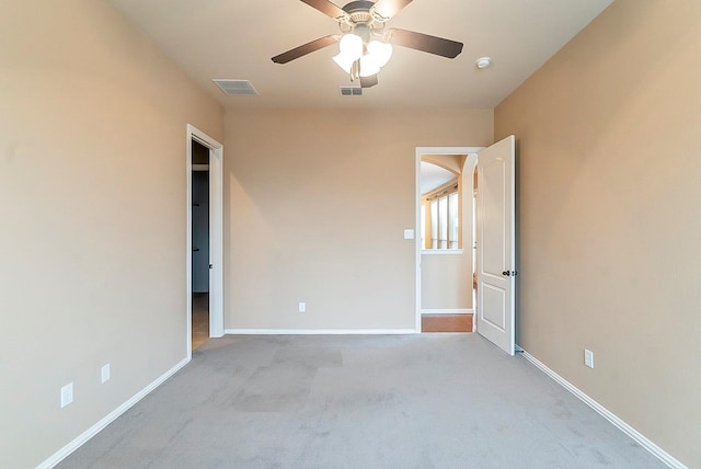 carpeted spare room with ceiling fan