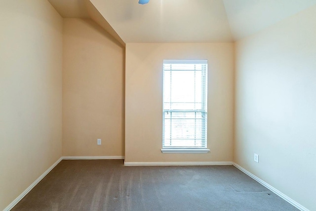 carpeted empty room with lofted ceiling and plenty of natural light