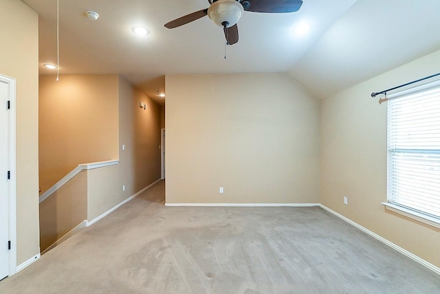 carpeted empty room featuring ceiling fan and lofted ceiling