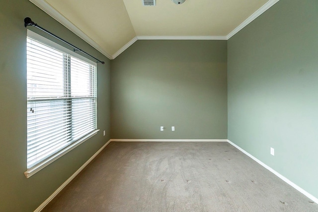 carpeted spare room with ornamental molding and vaulted ceiling