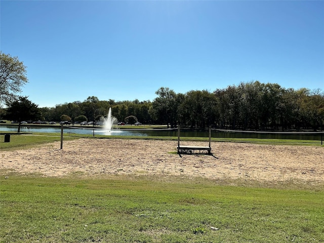 surrounding community featuring a water view and a yard