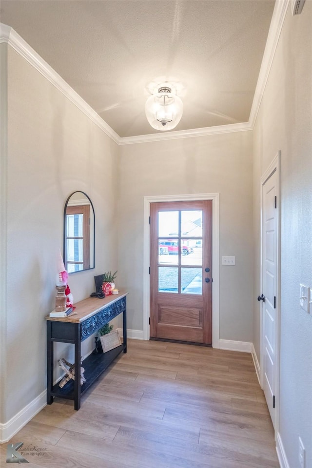 entrance foyer featuring crown molding and light hardwood / wood-style flooring