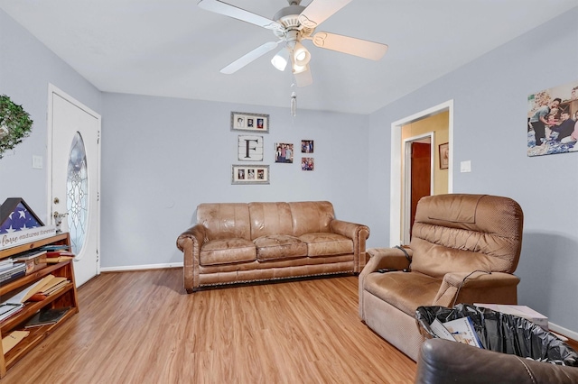 living room featuring ceiling fan and light wood-type flooring