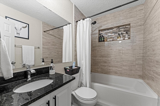 full bathroom featuring vanity, toilet, shower / bath combo with shower curtain, and a textured ceiling