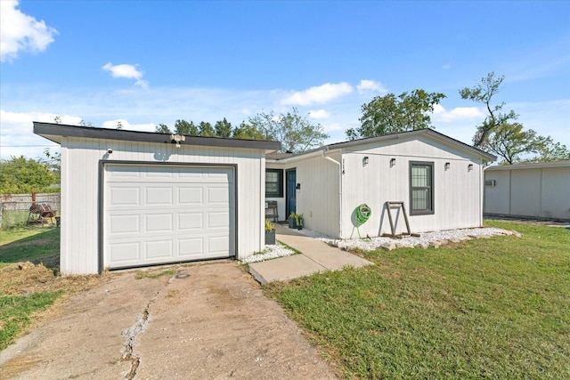 ranch-style house featuring a garage and a front yard