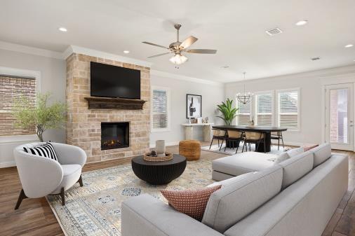 1476 Highland Park Cir, Granbury, TX 76048 - living area with ceiling fan with notable chandelier, crown molding, a fireplace, and wood finished floors