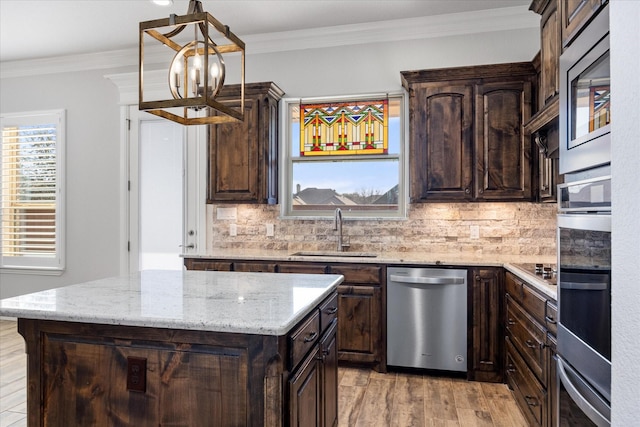 1476 Highland Park Cir, Granbury, TX 76048 - kitchen with ornamental molding, stainless steel appliances, dark brown cabinetry, a sink, and backsplash