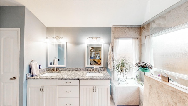 bathroom with a relaxing tiled tub and vanity