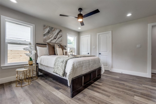 bedroom with wood-type flooring and ceiling fan