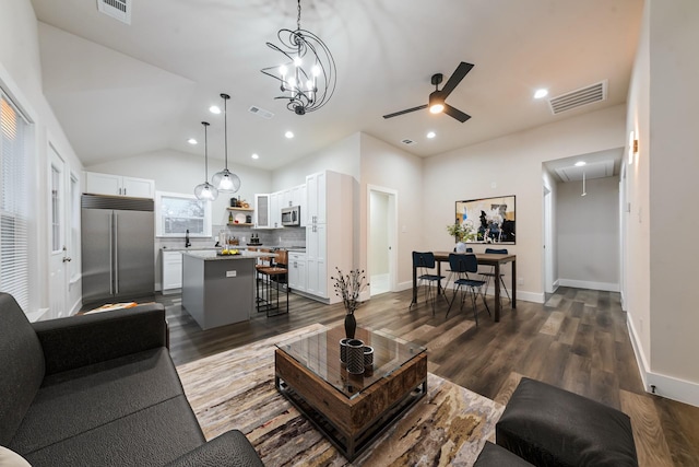 living room with vaulted ceiling and dark hardwood / wood-style floors