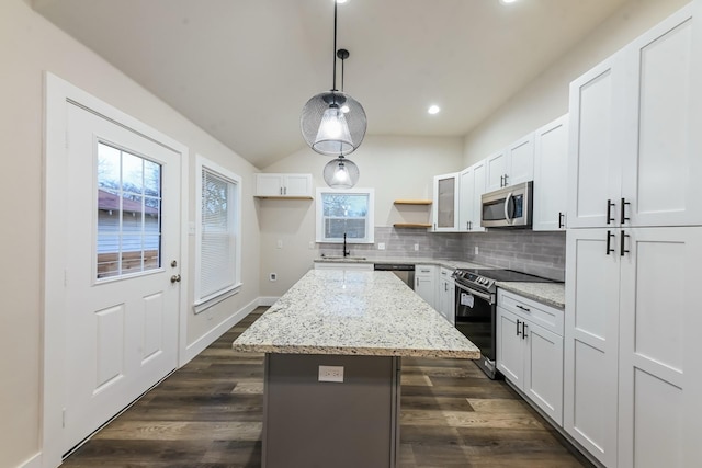 kitchen with pendant lighting, white cabinetry, stainless steel appliances, and a center island