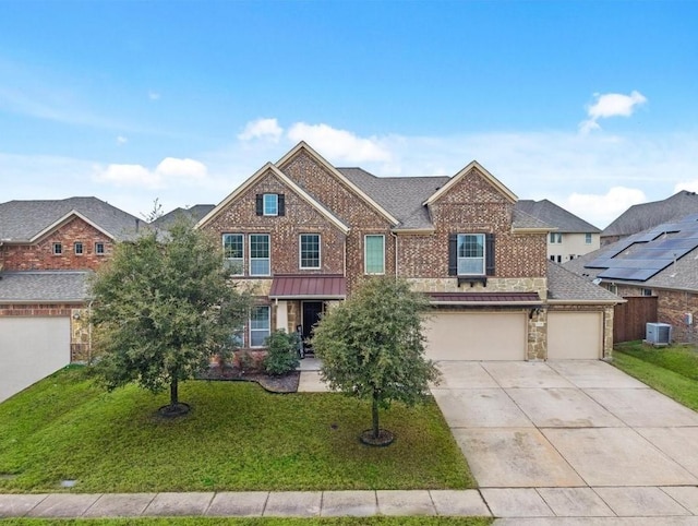 view of front of home featuring central AC, a garage, and a front yard