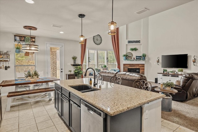 kitchen featuring visible vents, light tile patterned flooring, a sink, dishwasher, and open floor plan