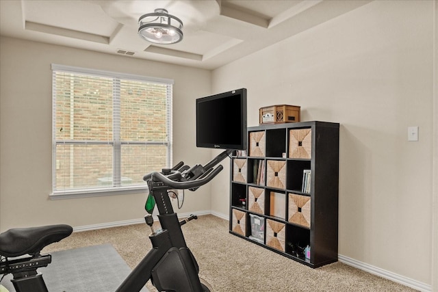 exercise room with visible vents, carpet, baseboards, and coffered ceiling