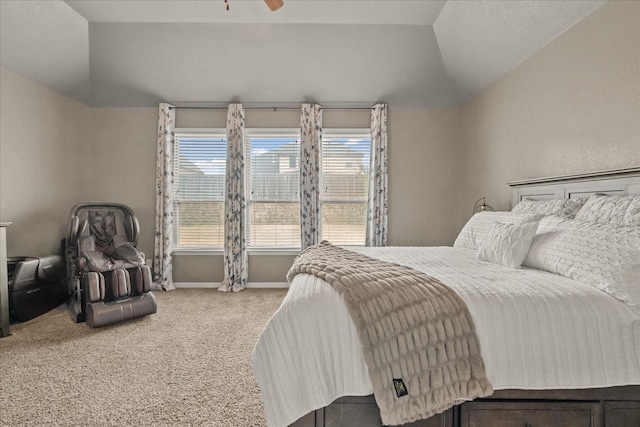 bedroom featuring lofted ceiling and carpet