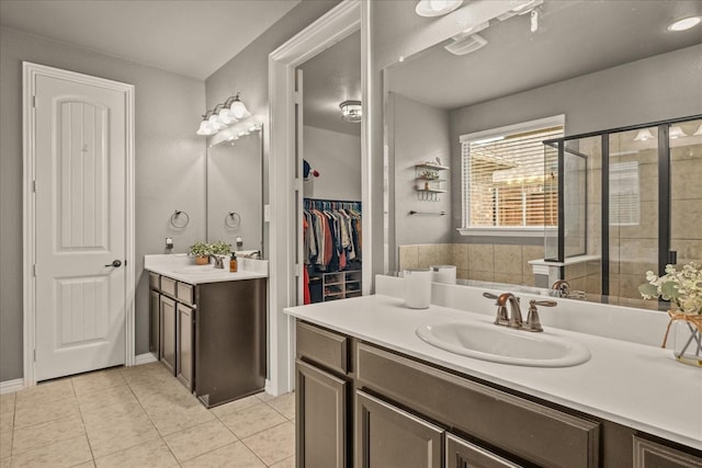 bathroom with tile patterned flooring, vanity, and an enclosed shower