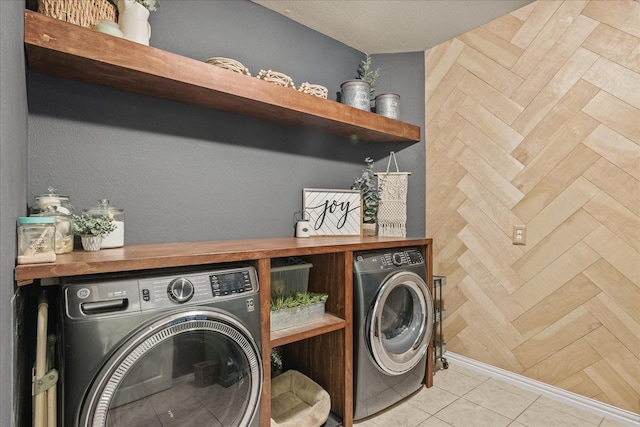 washroom with washing machine and clothes dryer and laundry area