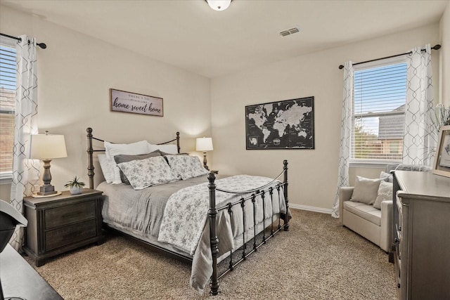 carpeted bedroom featuring visible vents and baseboards