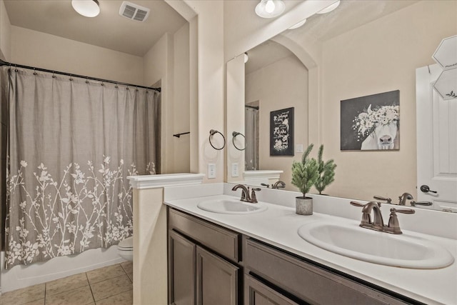 full bathroom featuring tile patterned flooring, toilet, vanity, and shower / bath combo with shower curtain