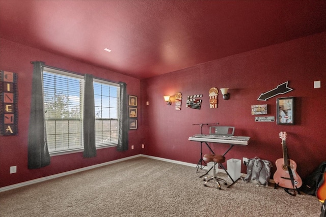 recreation room with baseboards and carpet floors