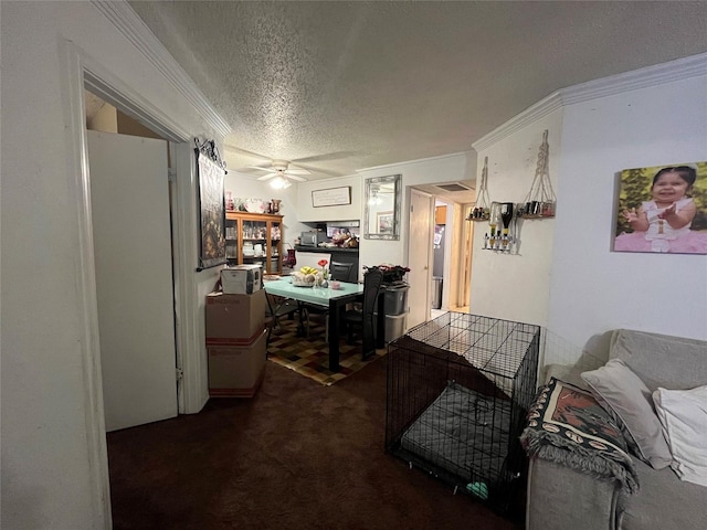 carpeted office featuring ornamental molding, ceiling fan, and a textured ceiling