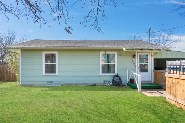 back of house with a lawn