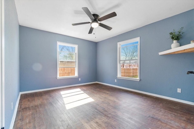 spare room featuring dark hardwood / wood-style flooring and ceiling fan