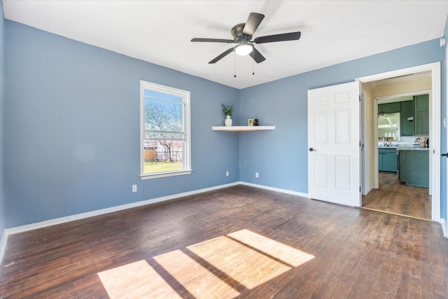 unfurnished bedroom featuring dark hardwood / wood-style floors and ceiling fan