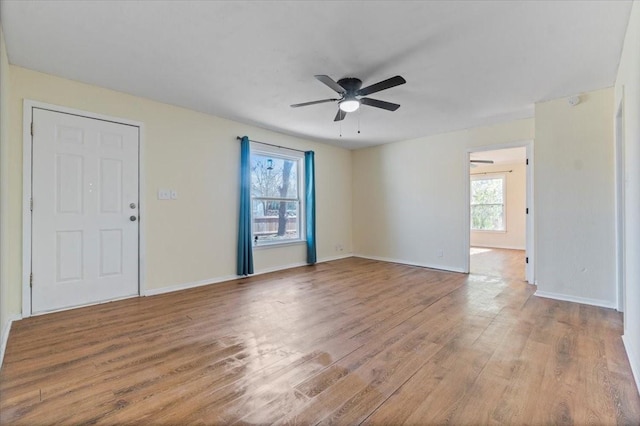 spare room featuring ceiling fan and light hardwood / wood-style flooring