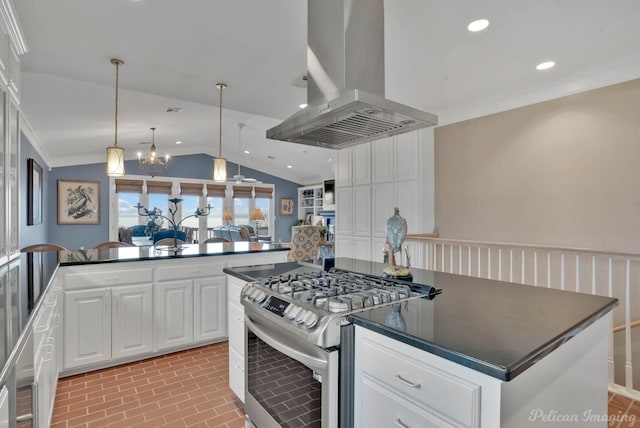 kitchen featuring stainless steel gas stove, island range hood, crown molding, and white cabinets