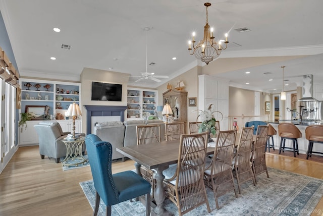 dining space featuring crown molding, built in shelves, light hardwood / wood-style floors, and ceiling fan